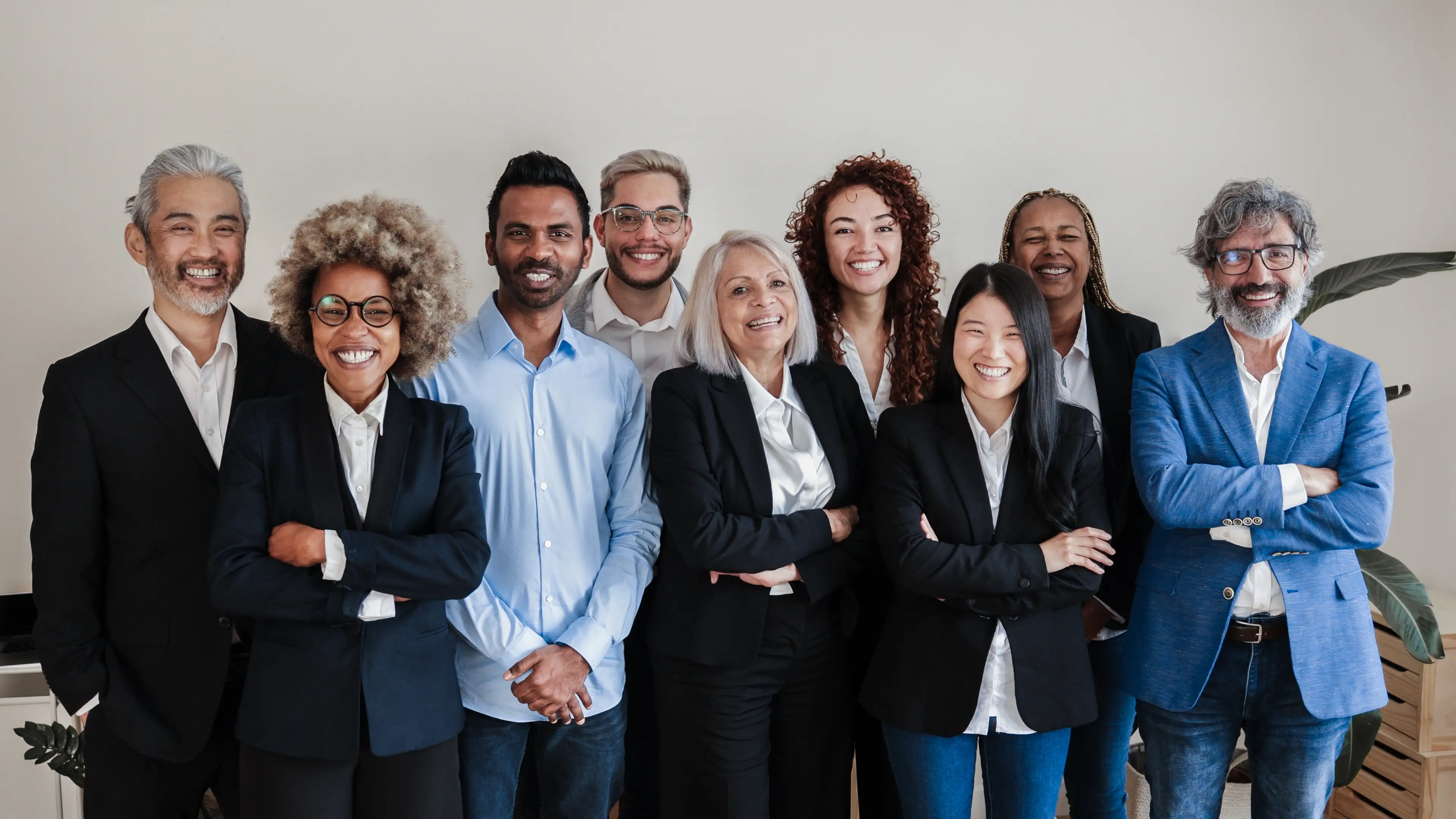 A team of colleagues standing together in their office